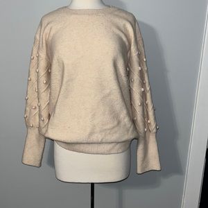 Pale pink sweater with dots on sleeve